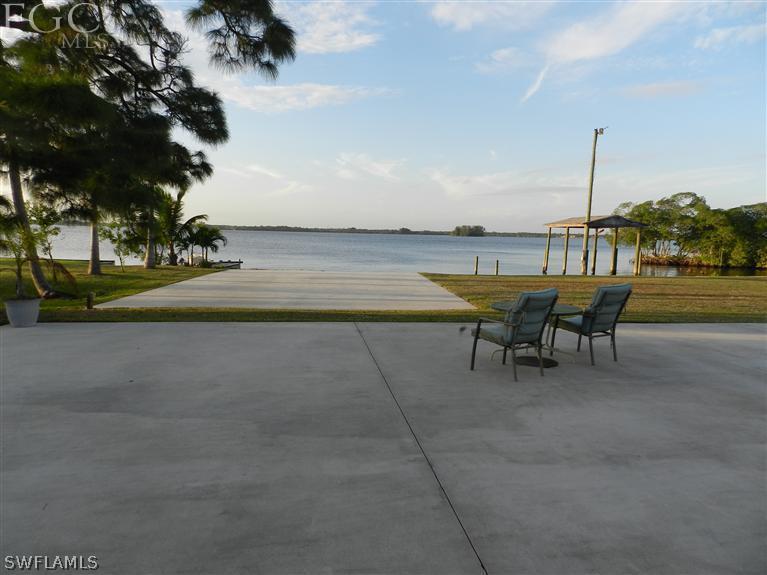 142 Riverview Road Fort Myers, FL 33905 - Photo 3 of 13 a swimming pool with outdoor seating and yard