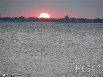 142 Riverview Road Fort Myers, FL 33905 - Photo 6 of 13 a view of a lake with a mountain in the background