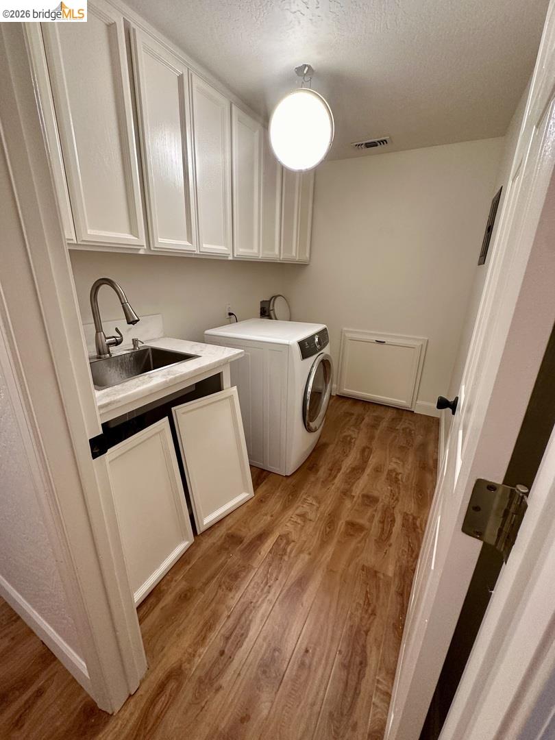 2080 Nelson Road Camino, CA 95709 - Photo 49 of 55 White shaker cabinetry, wood-finish flooring, undermount utility sink, and recessed lighting
