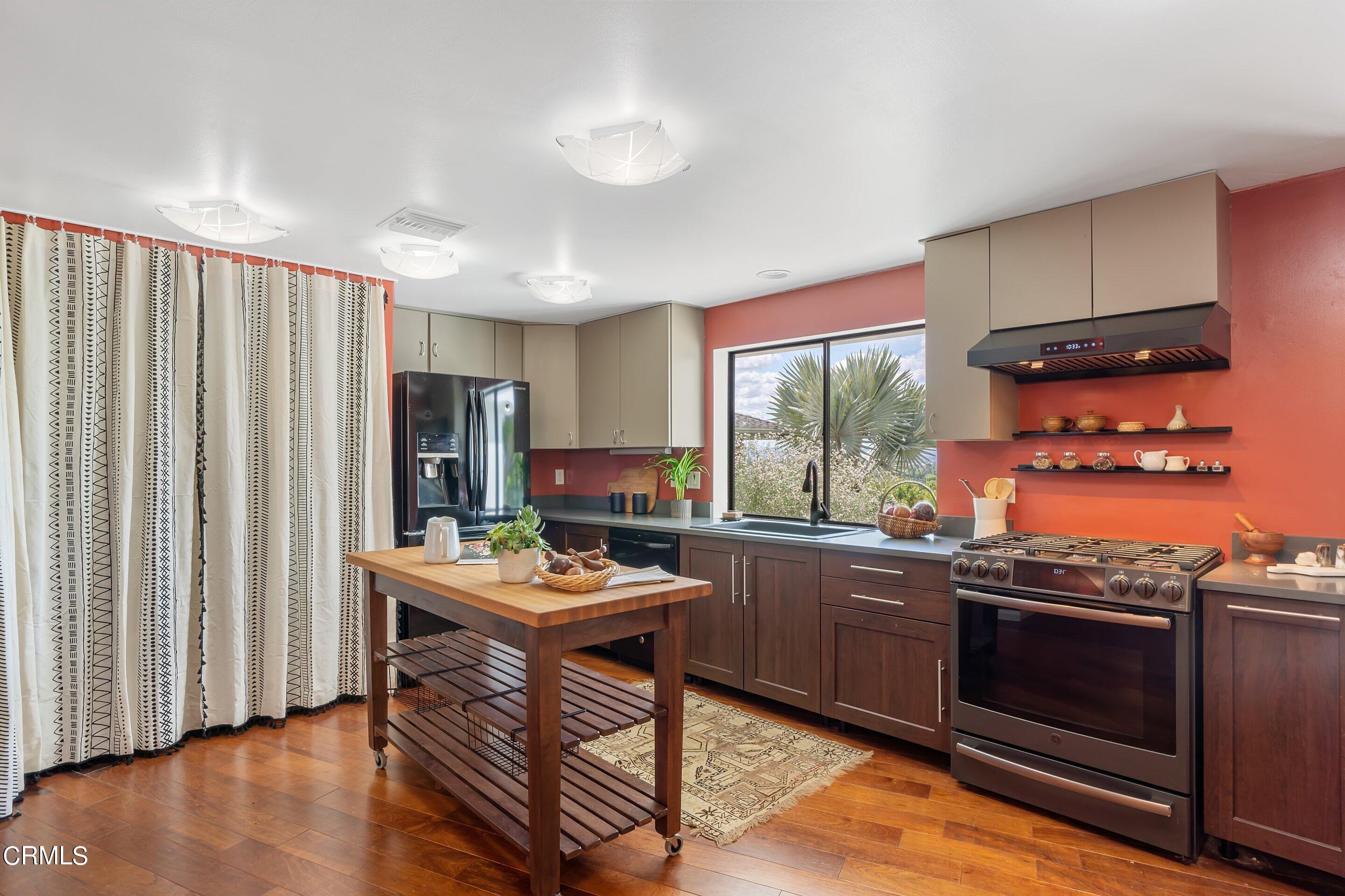 917 Crescent Drive Monrovia, CA 91016 - Photo 11 of 28 a kitchen with stainless steel appliances granite countertop a stove top oven a sink and a refrigerator