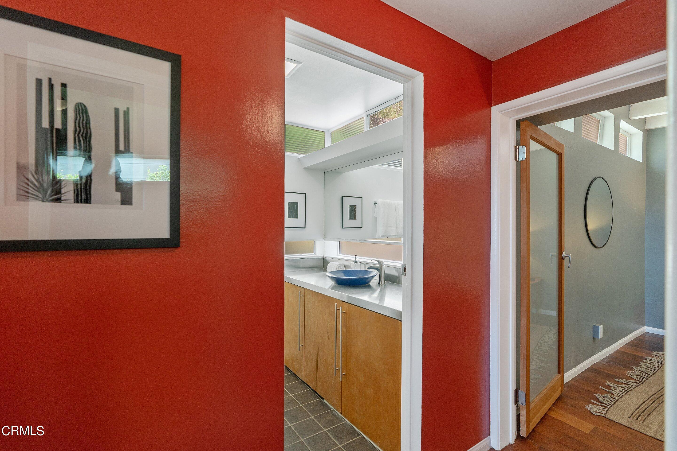 917 Crescent Drive Monrovia, CA 91016 - Photo 21 of 28 a en suite bathroom with a granite countertop sink and a mirror