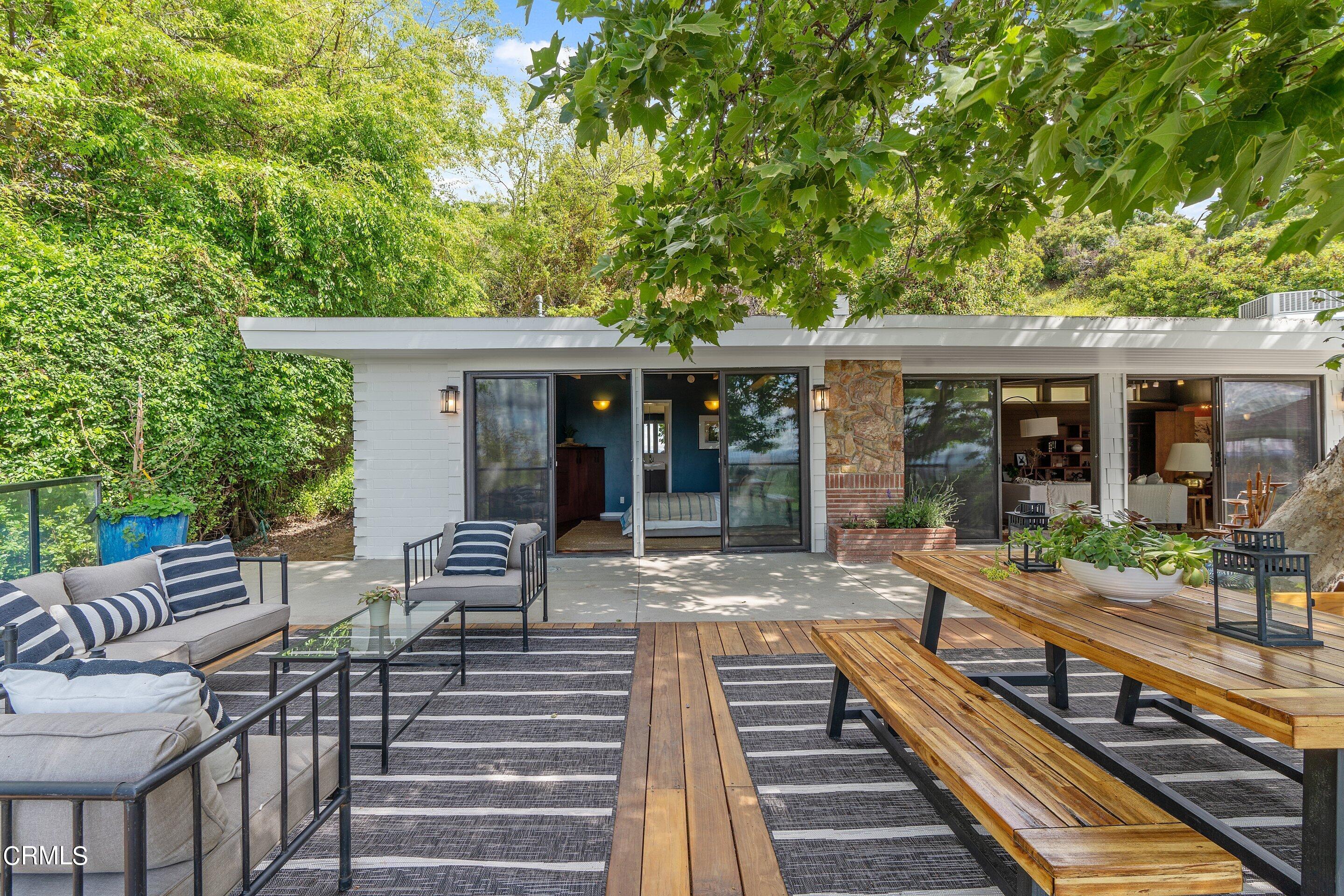 917 Crescent Drive Monrovia, CA 91016 - Photo 23 of 28 a view of a patio with table and chairs with wooden floor and fence