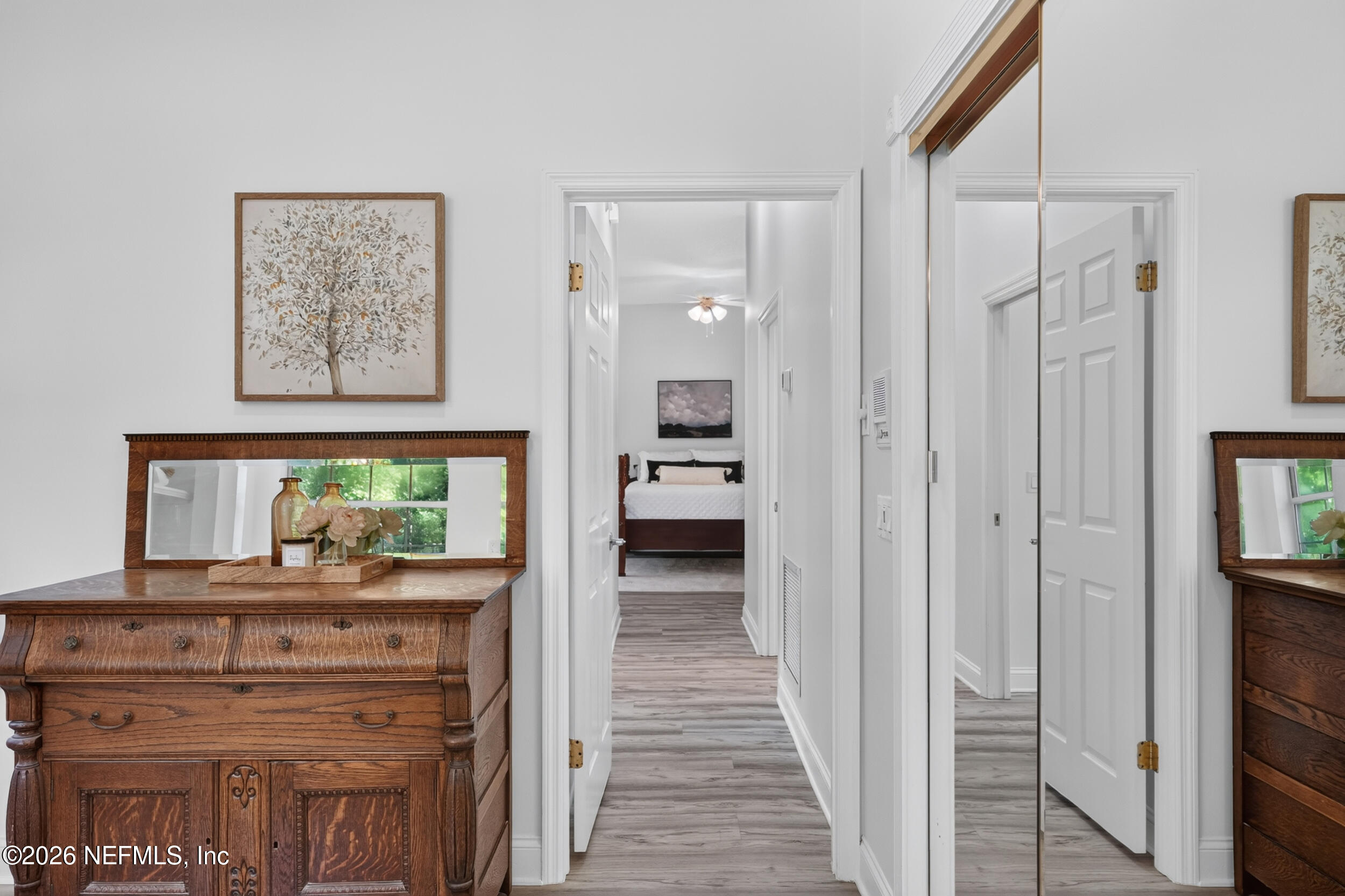 3090 Monument Bay Road St. Augustine, FL 32092 - Photo 28 of 56 a view of a hallway to a livingroom with wooden floor and a cabinet