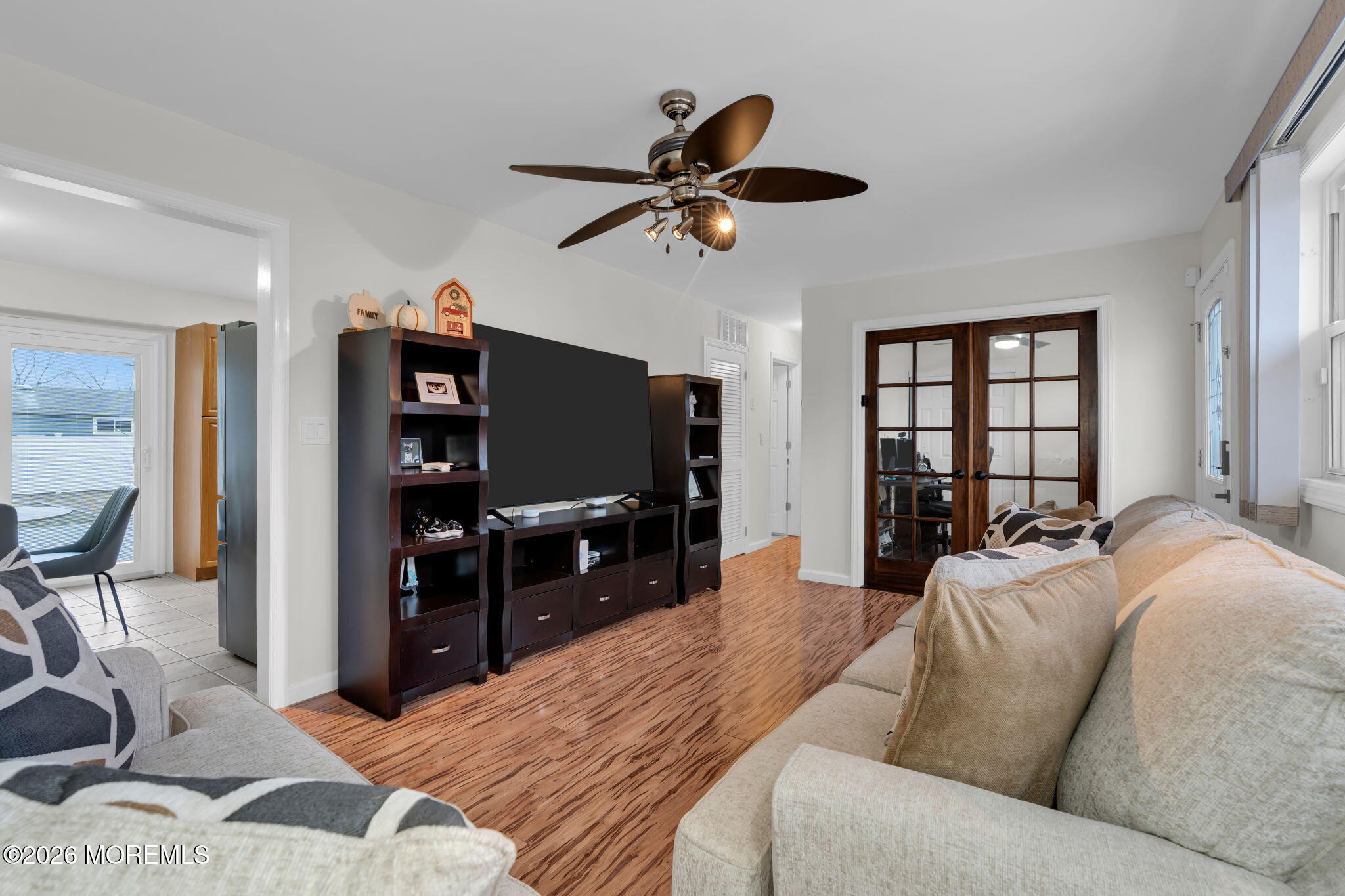31 Colgate Drive Toms River, NJ 08757 - Photo 12 of 34 a living room with furniture a ceiling fan a flat screen tv and a window