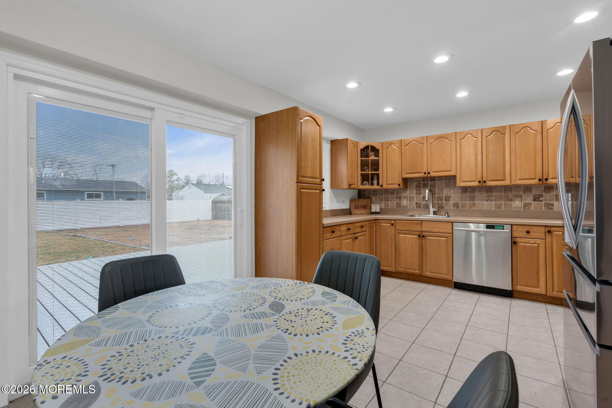 31 Colgate Drive Toms River, NJ 08757 - Photo 14 of 34 a kitchen with stainless steel appliances granite countertop a sink a stove a refrigerator cabinets and a dining table