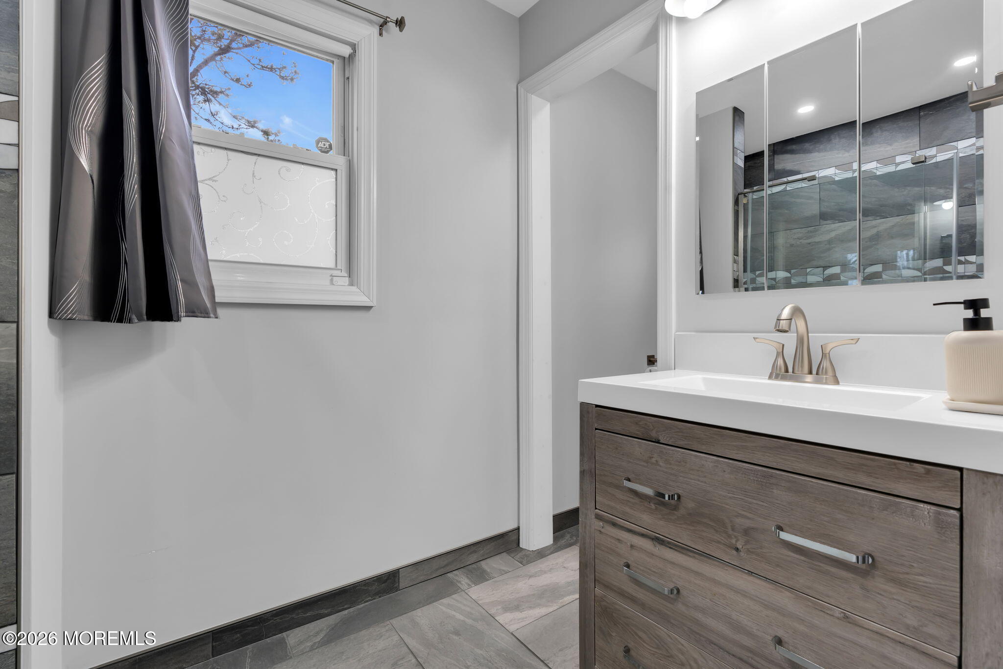 31 Colgate Drive Toms River, NJ 08757 - Photo 24 of 34 a bathroom with a sink and a mirror