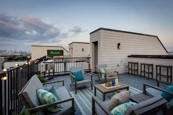 a balcony with furniture and wooden floor