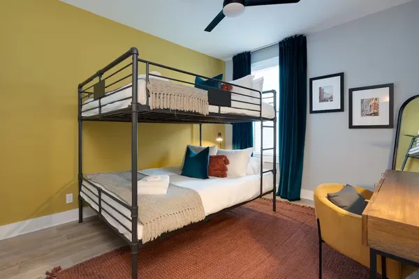 a bedroom with a bed and a mirror