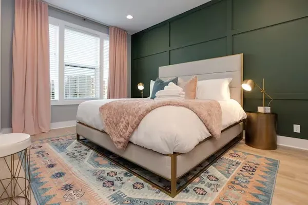 a bedroom with a bed and a lamp