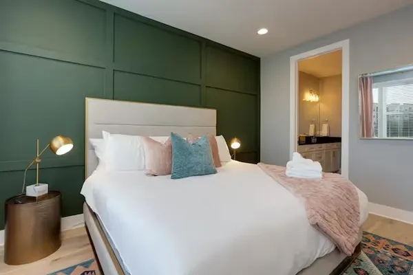 a bedroom with a large bed and a window