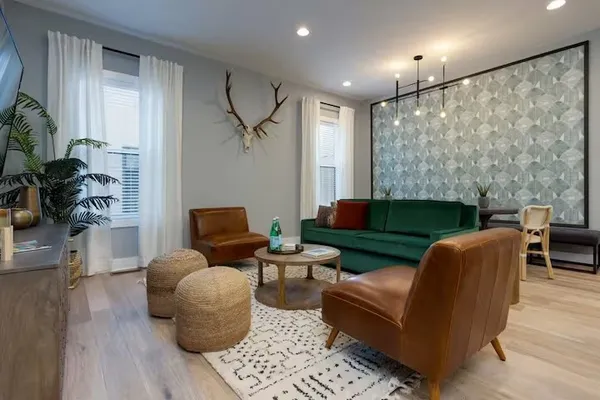 a living room with furniture potted plant and a fireplace