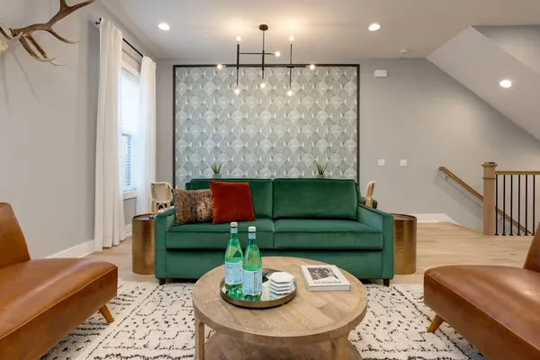 a living room with furniture and a dining table with kitchen view