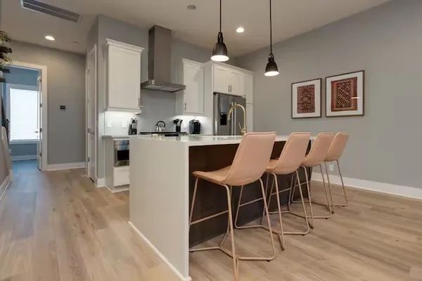 a kitchen with a sink stove and cabinets