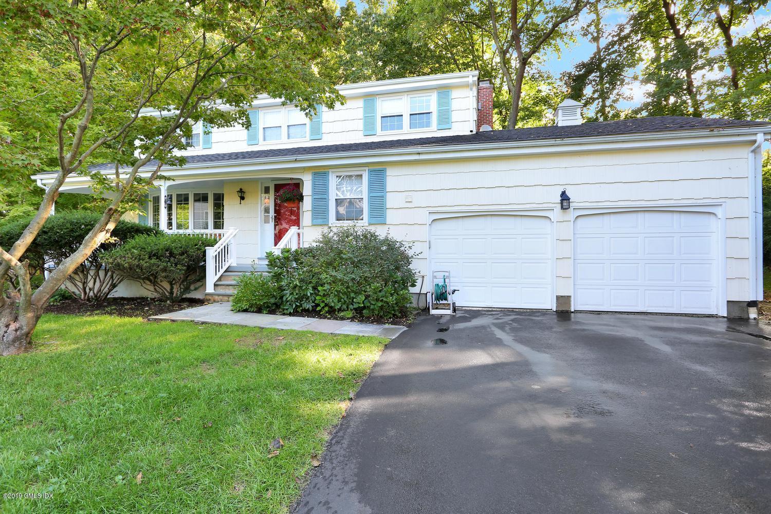 28 Revere Road Riverside, CT 06878 - Photo 1 of 29 a front view of a house with a yard and garage
