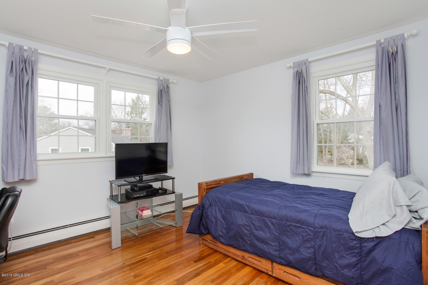 28 Revere Road Riverside, CT 06878 - Photo 12 of 29 a bedroom with a bed window and a flat screen tv