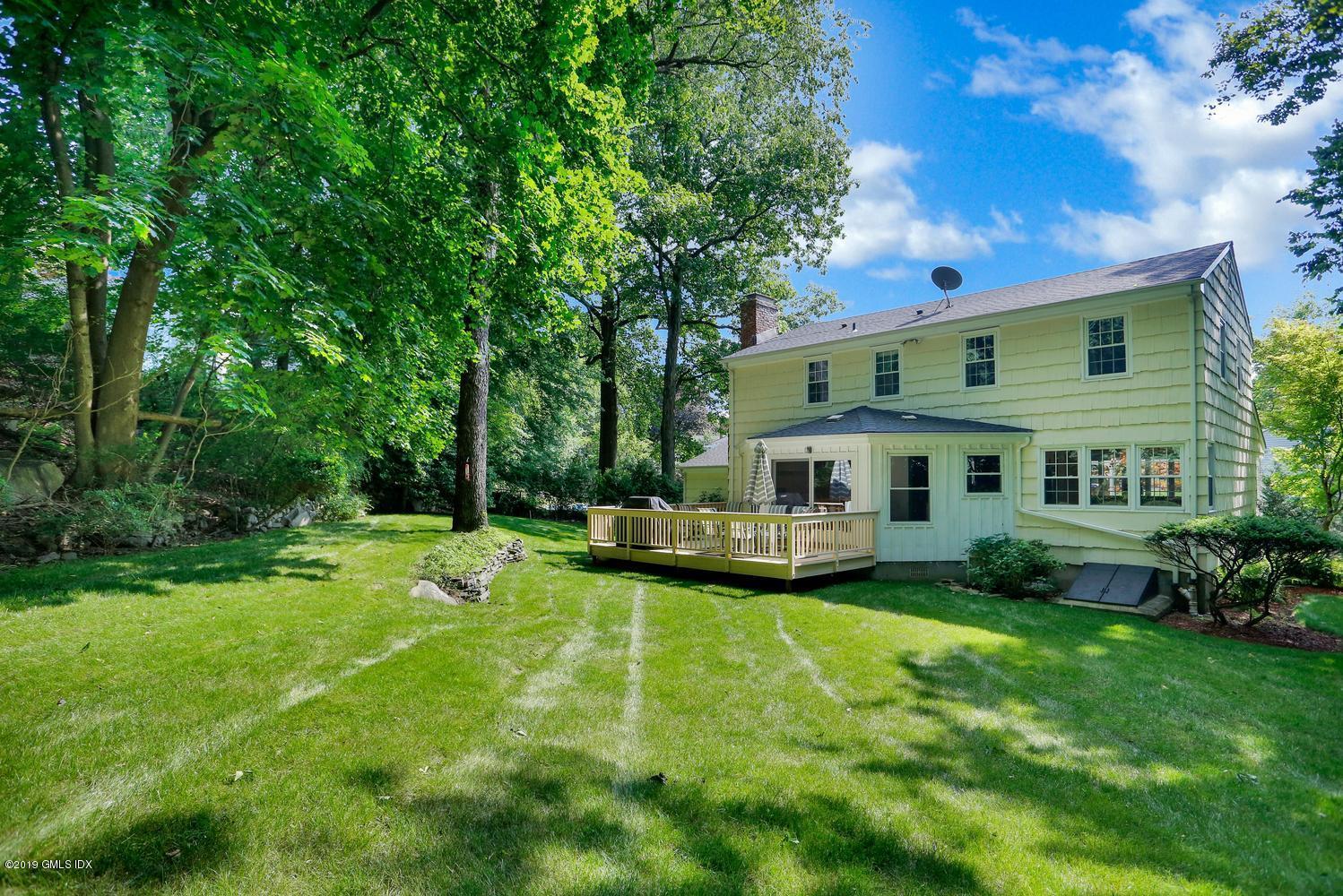 28 Revere Road Riverside, CT 06878 - Photo 29 of 29 a view of a house with a big yard potted plants and large tree