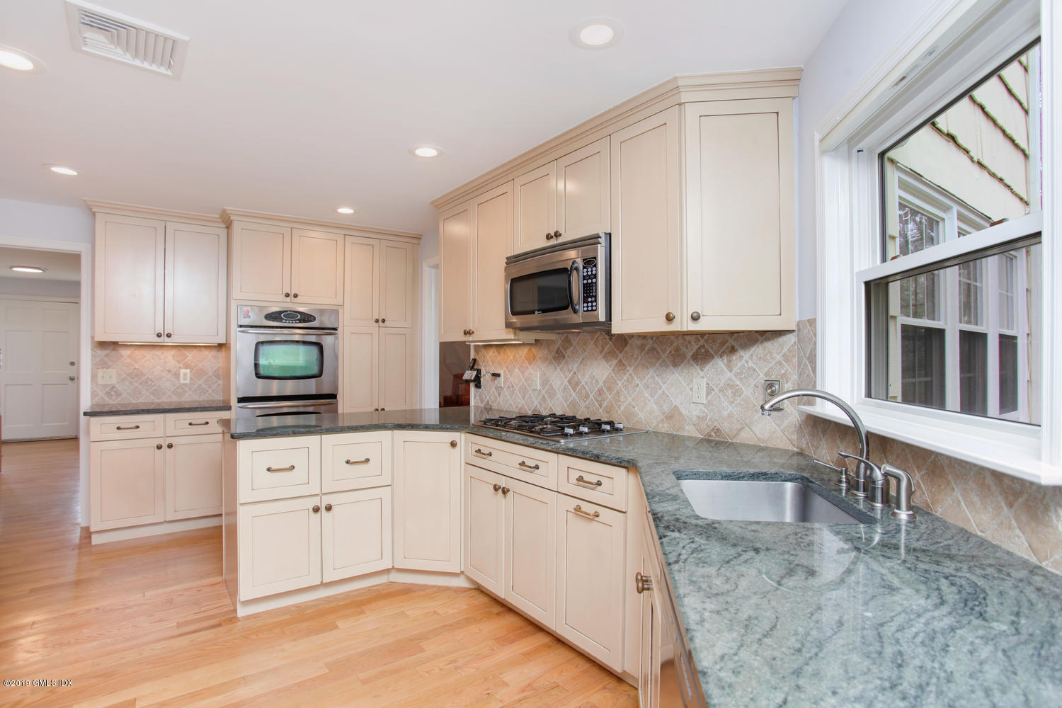 28 Revere Road Riverside, CT 06878 - Photo 4 of 29 a kitchen with granite countertop a stove top oven sink and cabinets