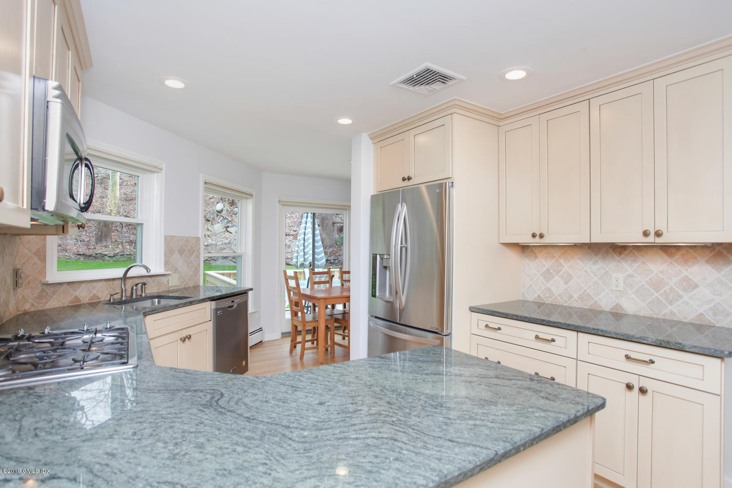 28 Revere Road Riverside, CT 06878 - Photo 5 of 29 a kitchen with granite countertop a refrigerator and a stove top oven