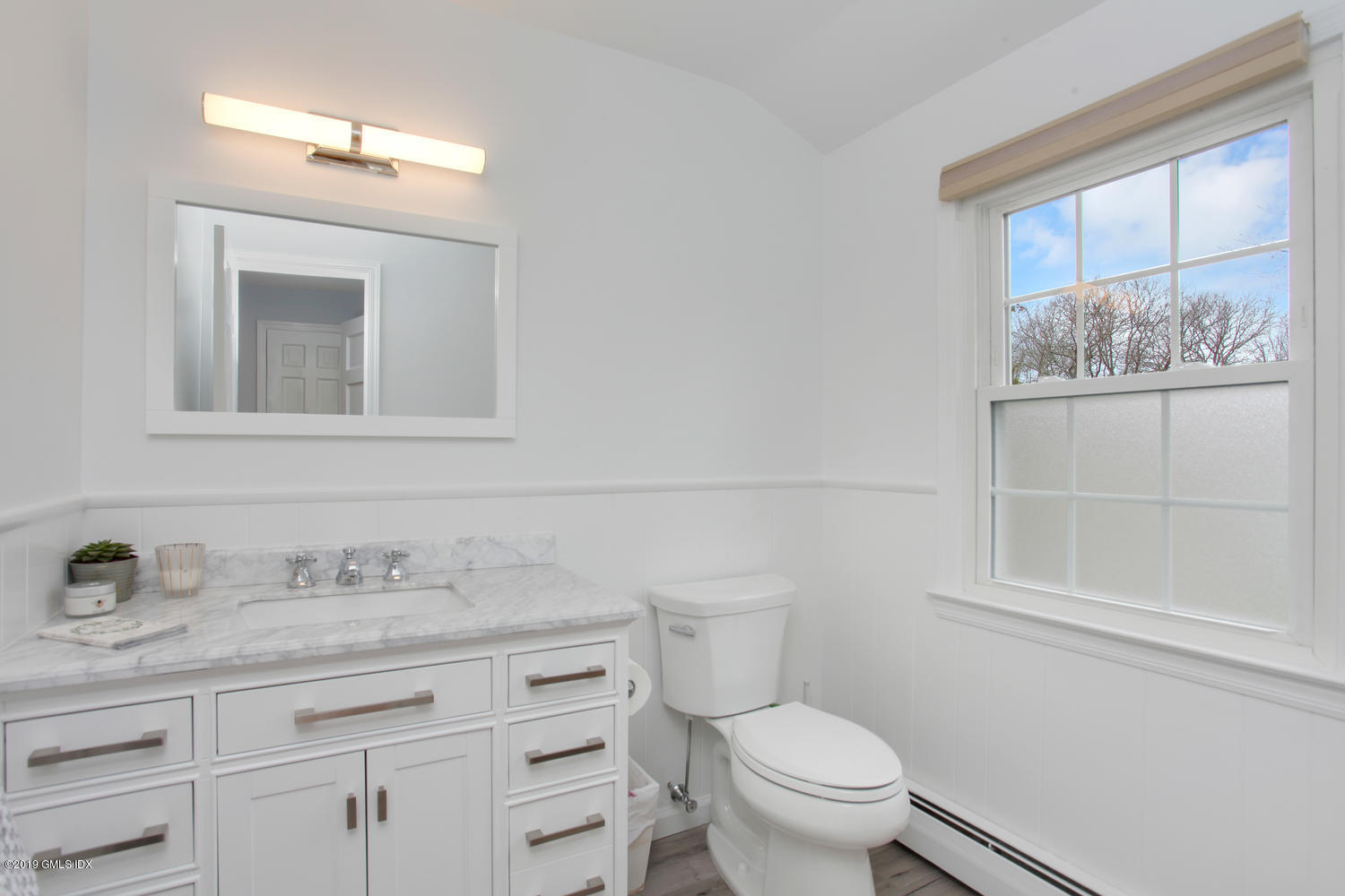 28 Revere Road Riverside, CT 06878 - Photo 7 of 29 a bathroom with a granite countertop toilet sink and mirror