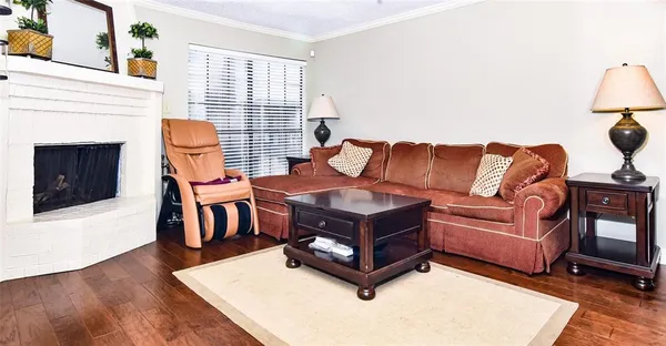 a living room with furniture a fireplace and a table