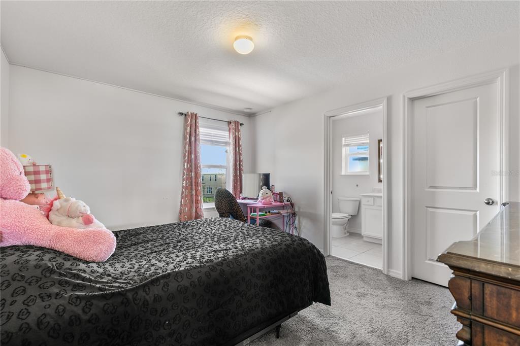 5637 Beggs Road St. Cloud, FL 34771 - Photo 21 of 35 a bedroom with a bed and a dresser
