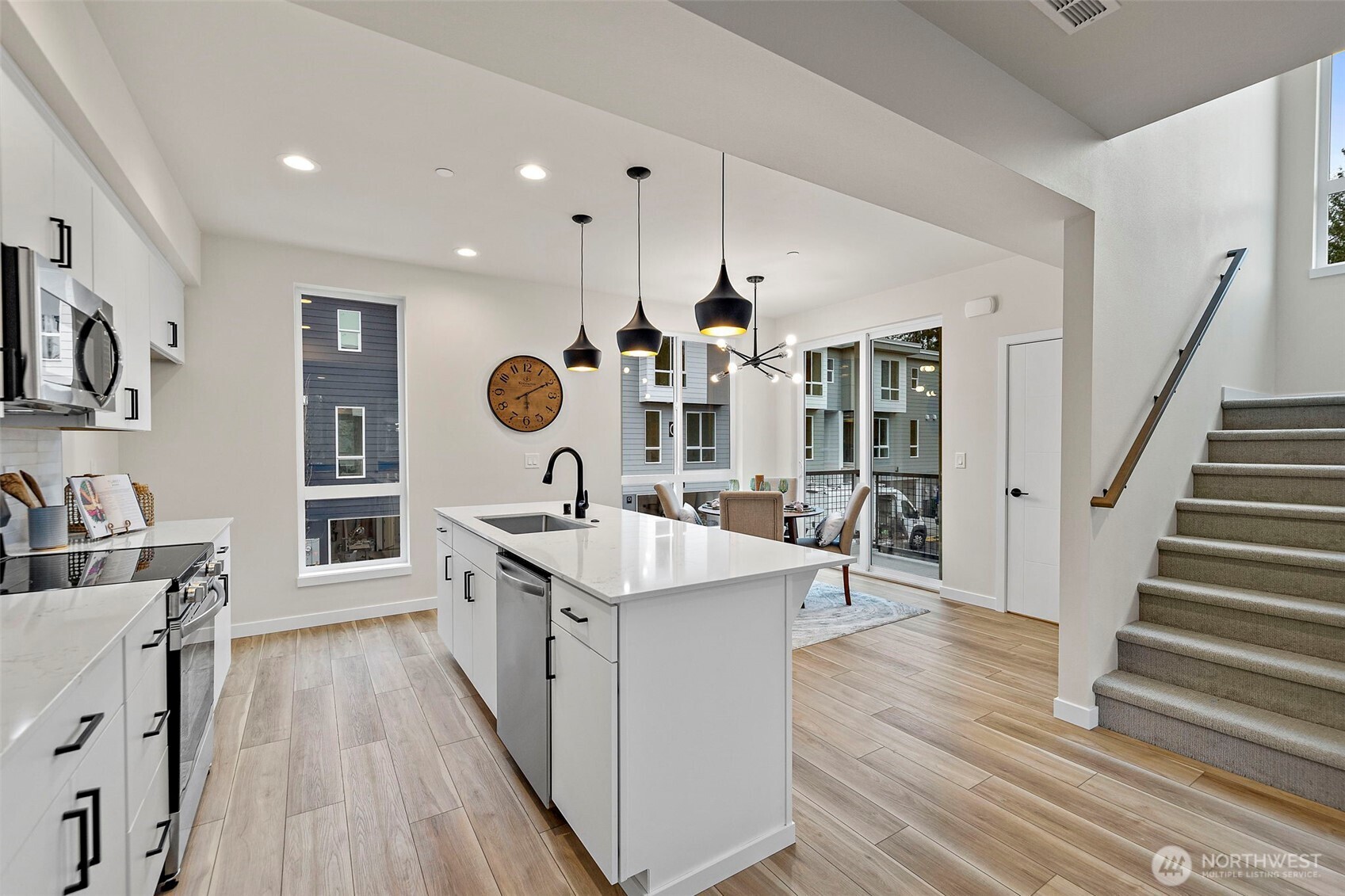 5015 144th Street Southwest, Unit B3 Edmonds, WA 98026 - Photo 14 of 39 a large kitchen with stainless steel appliances kitchen island granite countertop a sink and cabinets
