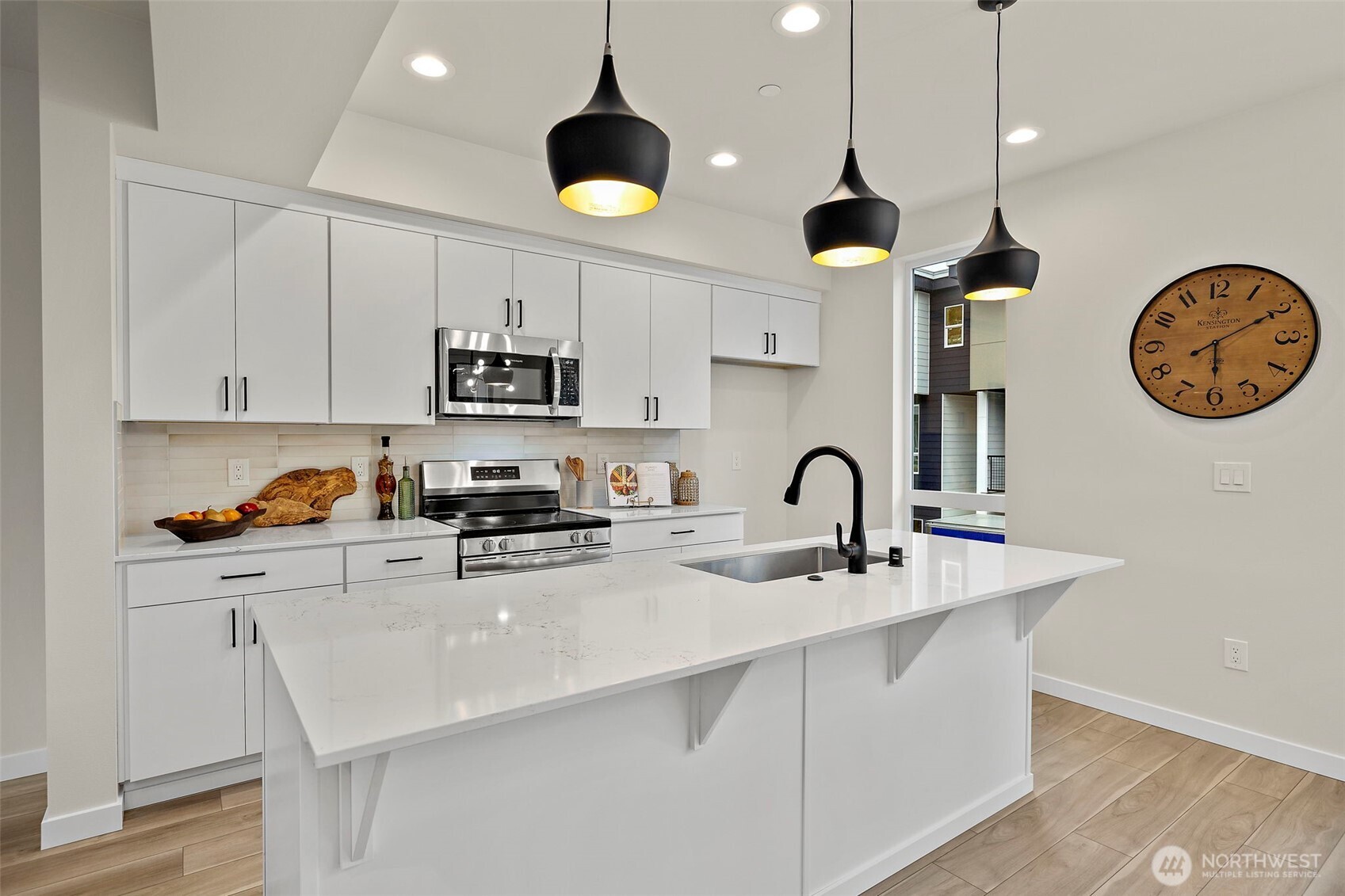 5015 144th Street Southwest, Unit B3 Edmonds, WA 98026 - Photo 8 of 39 a kitchen with stainless steel appliances granite countertop a stove a sink a oven a dining table and chairs with wooden floor