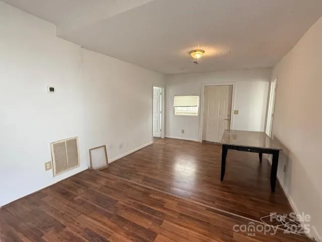 a view of room with window and wooden floor