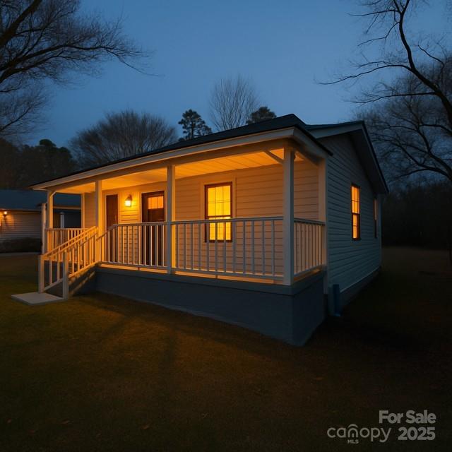 104 Price Street Mount Holly, NC 28120 - Photo 2 of 37 a backyard of a house with wooden deck and outdoor seating