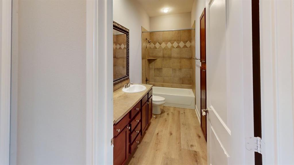 4904 Live Oak Street, Unit 1 Dallas, TX 75206 - Photo 14 of 20 a bathroom with a granite countertop sink and a mirror