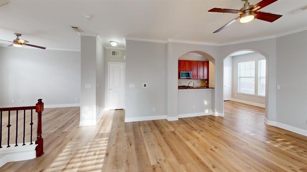 4904 Live Oak Street, Unit 1 Dallas, TX 75206 - Photo 5 of 20 a view of empty room with wooden floor and fan