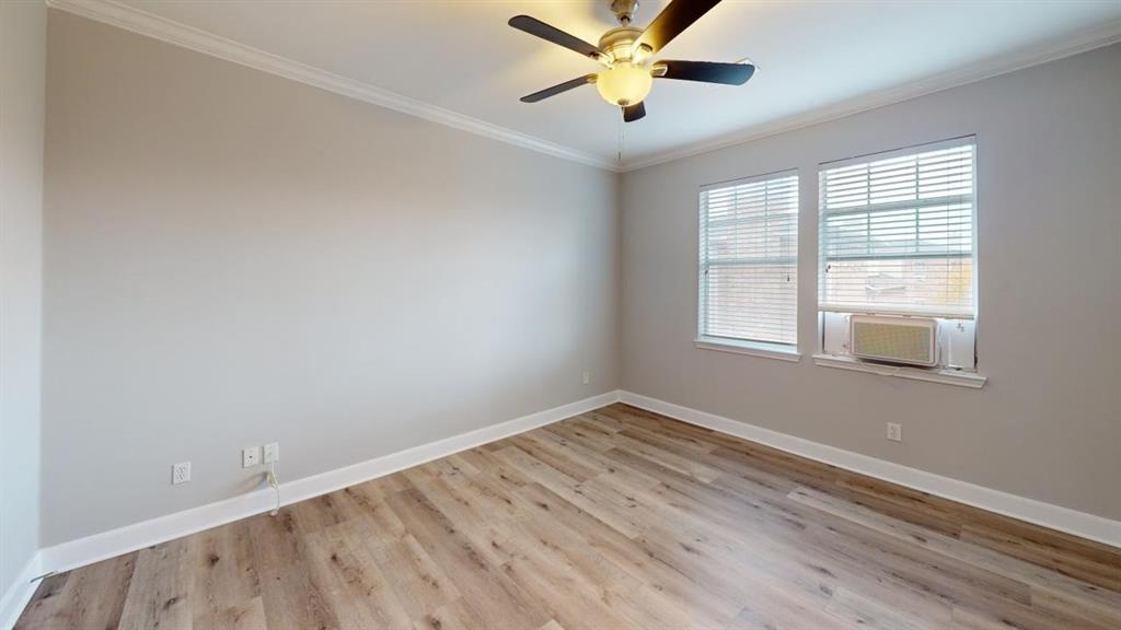 4904 Live Oak Street, Unit 1 Dallas, TX 75206 - Photo 9 of 20 an empty room with a window and a fan