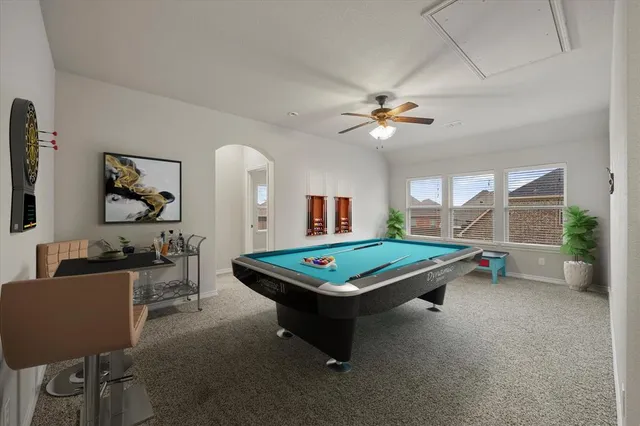 a living room with furniture a table and a chandelier