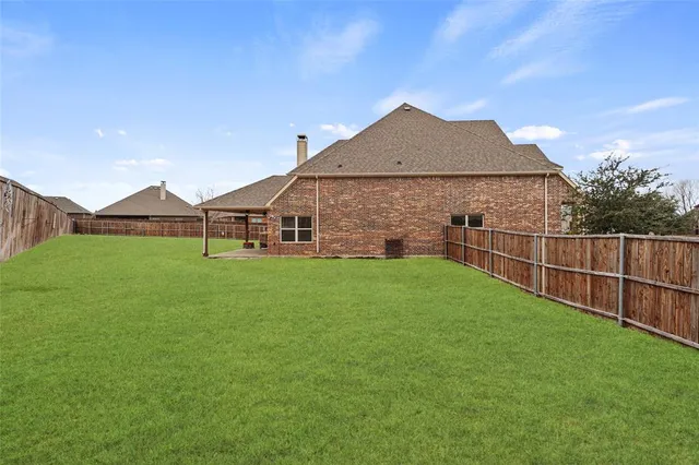 a view of a house with a yard and sitting area