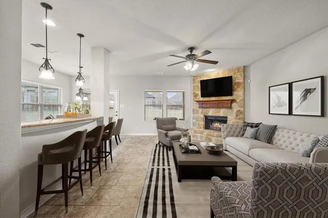 a living room with furniture a fireplace and a flat screen tv