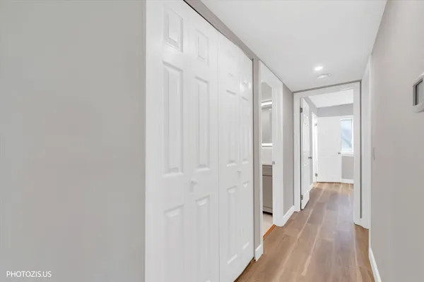 a view of a hallway with wooden floor