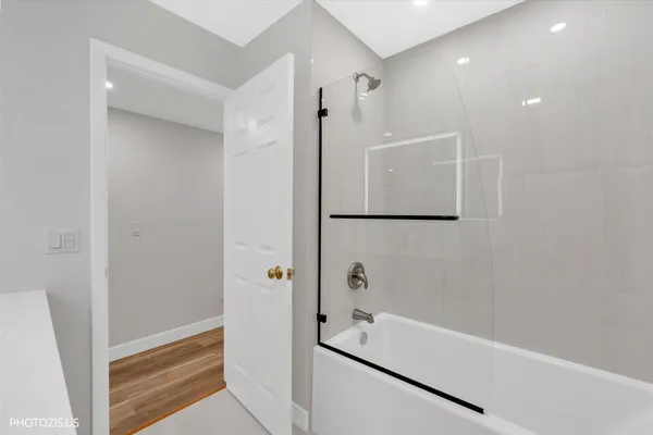 a bathroom with a bathtub and a shower