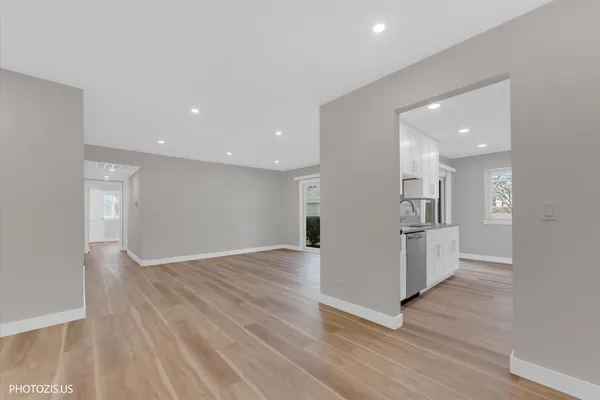 a view of empty room with wooden floor
