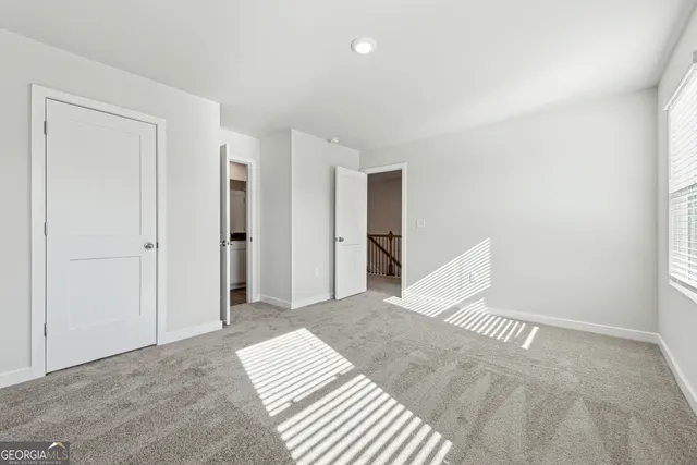 a view of a bedroom with wooden floor and closet
