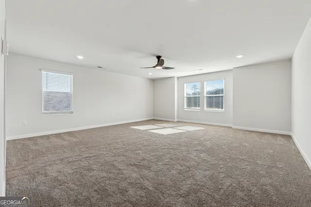 an empty room with windows and closet