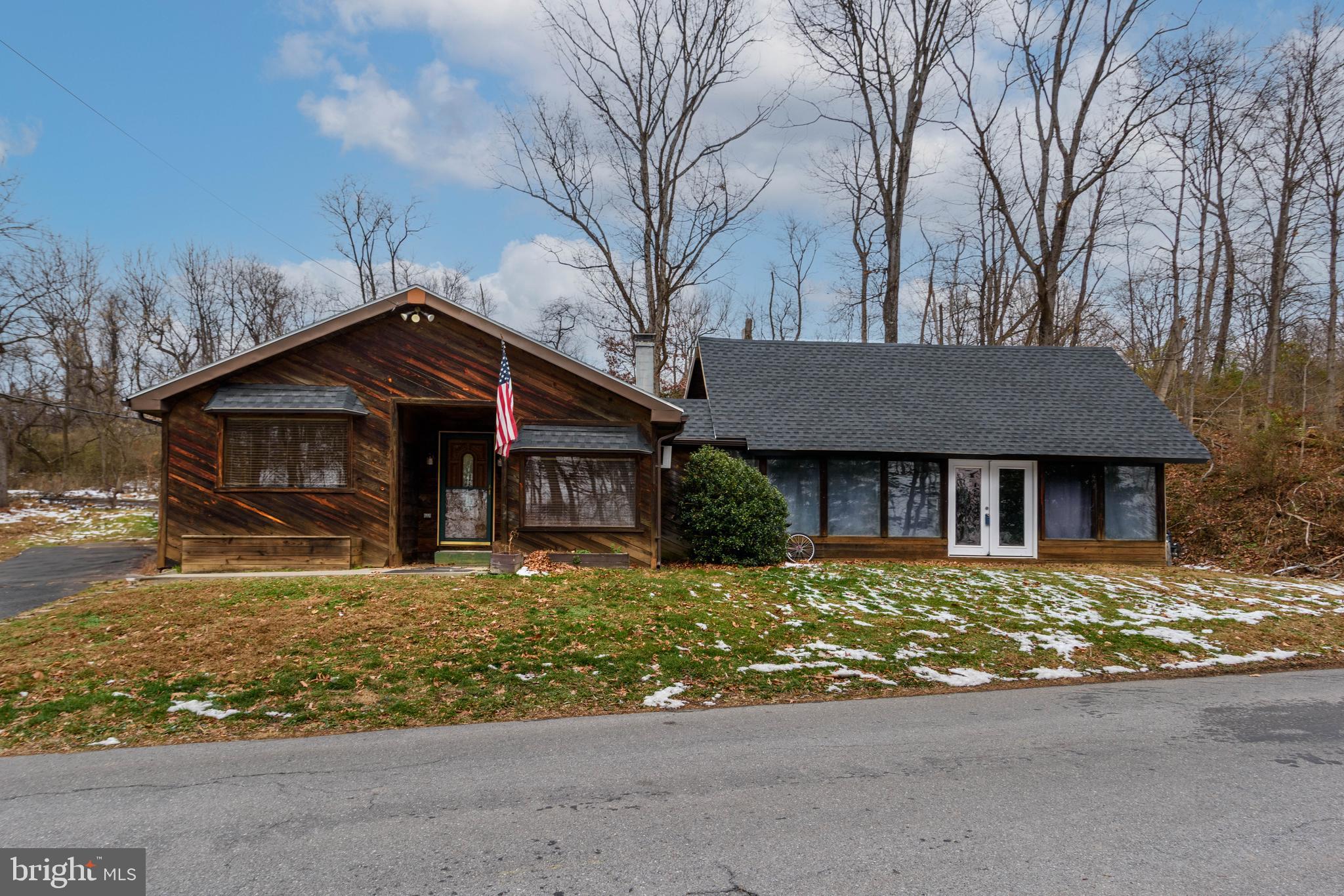 a front view of a house with a yard covered with snow