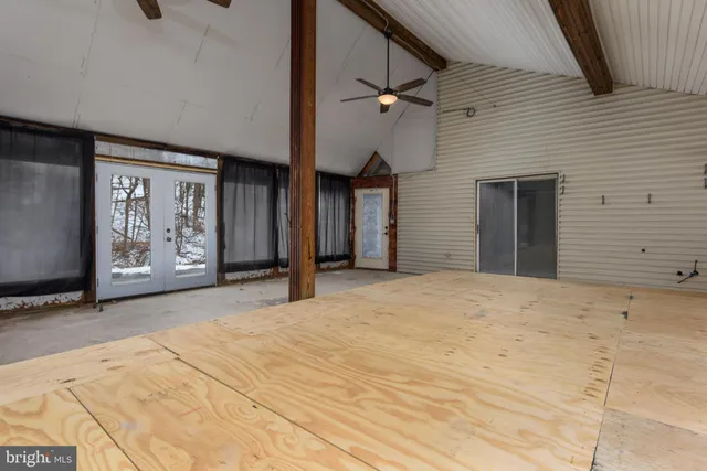 a view of a patio with table and chairs and wooden floor