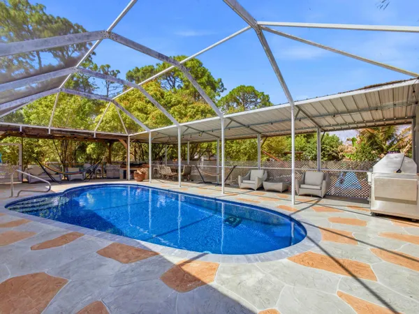 a view of a swimming pool with a patio