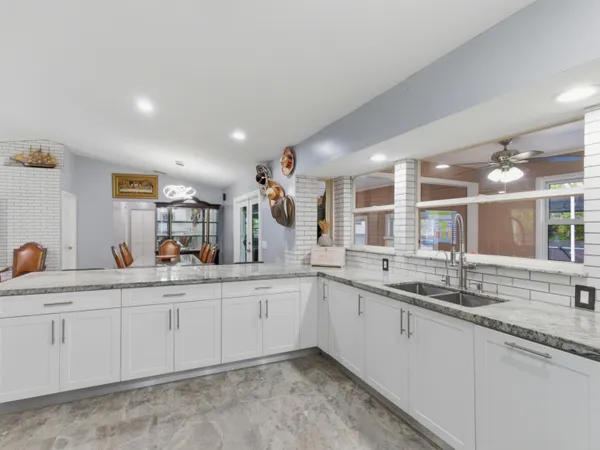 a large kitchen with a sink and cabinets