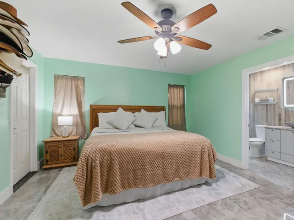 a bedroom with a large bed and a chandelier
