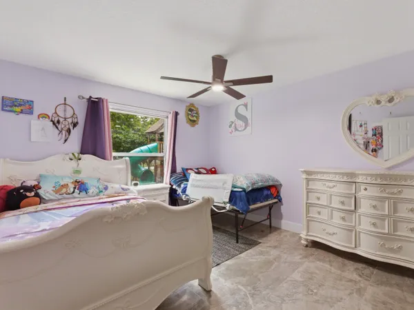 a bedroom with furniture and a window