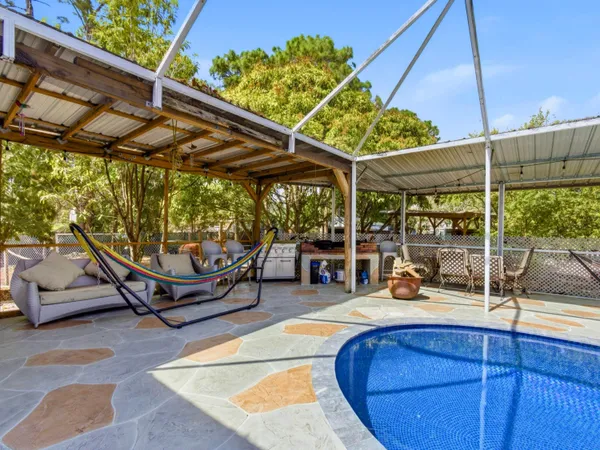 a view of a swimming pool with a patio