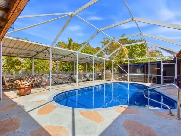 a view of a backyard with a patio and dining table