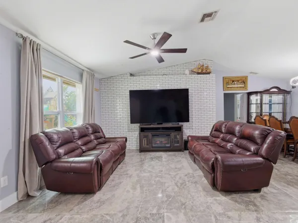 a living room with furniture and a flat screen tv