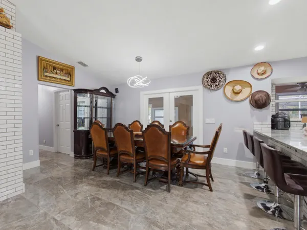 a view of a dining area with furniture and chandelier